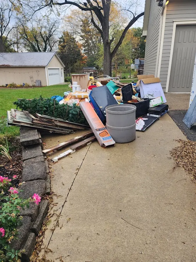 Dumpster being loaded with debris for Demolition Dumpster Rental in Ellsworth